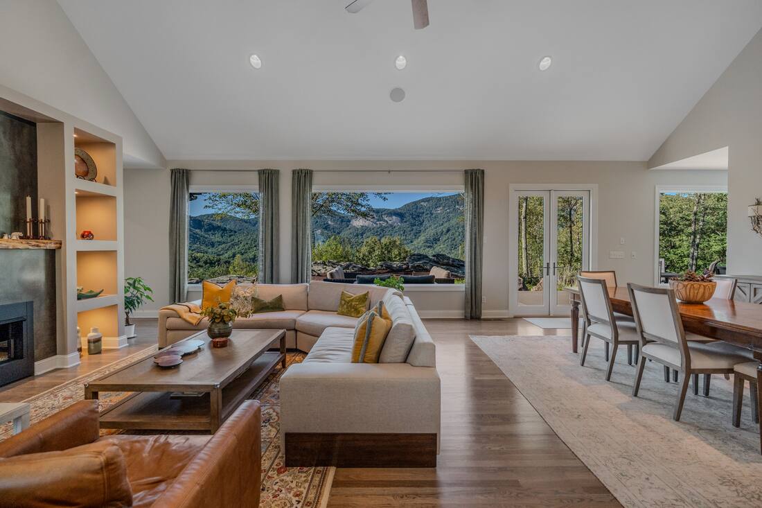 Great room and dining area with picture windows on the mountains